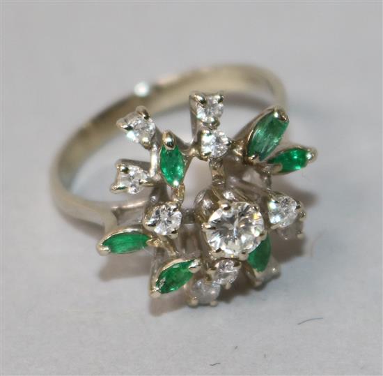 An 18k white gold, emerald and diamond cluster dress ring, size O.